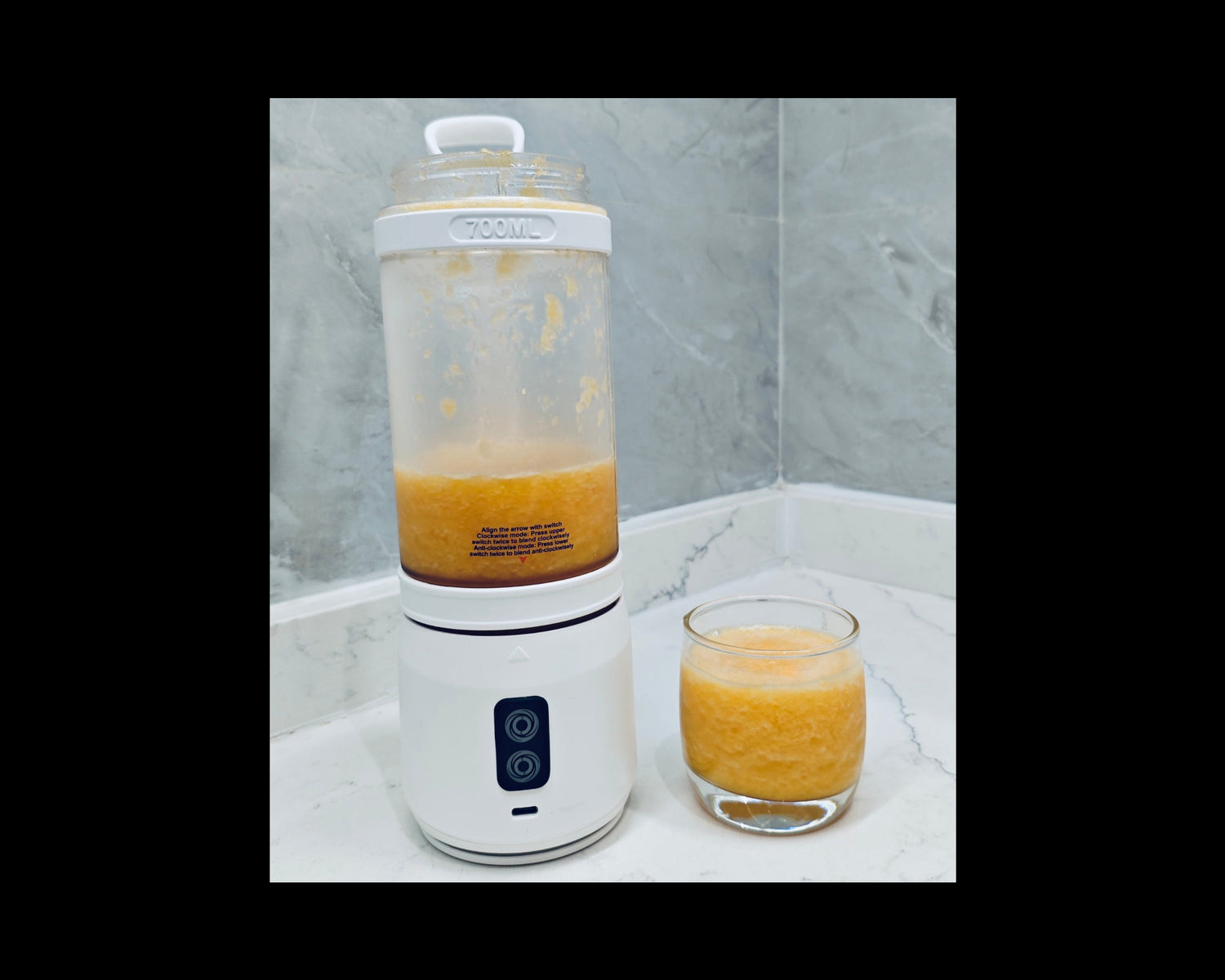 Orange juice smoothie filled in blender and cup