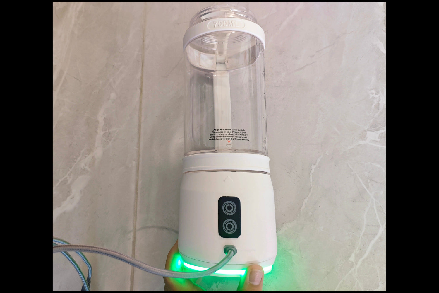 PowerSip Vortex, plugged into a USBC charging cable, charging, green base light